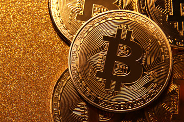 Bitcoin over golden glitter background. Business concept.