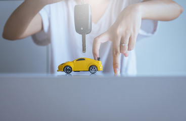 Car key on hand for vehicle sales agreement,Car finance and loan concept