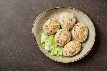 Dietary chicken cutlets with salad leaf on plate