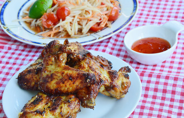 Thai Papaya salad or Thai name is somtom with chicken grilled and sauce