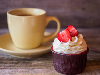 capcake with strawberries and a cup of coffee