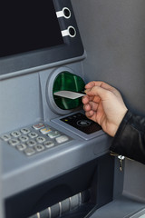 Woman using ATM to withdraw money 