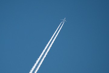 White aircraft on the clear blue sky background