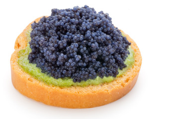 Canapes with black sturgeon caviar on the isolated white background.