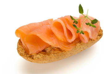 Bread with fresh salmon fillet isolated on white background, top view.