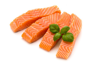 Fresh salmon fillet with basil on the white background.