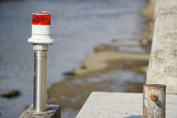 Electric signal lantern on the river water canal, beacon for the boats