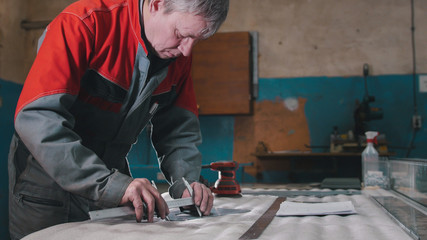 Engineer use trammel technician measuring cutting tool before cnc milling machine center at tool workshop