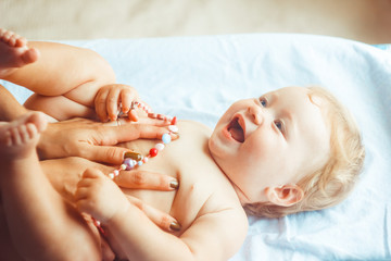 a small child lies on the sheet