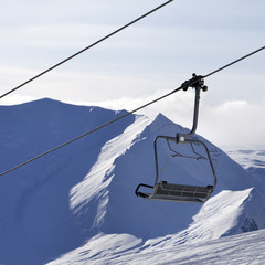 Chair lift and mountains in evening