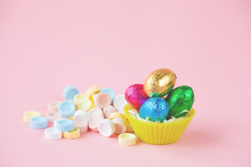 Fototapeta na wymiar Easter Eggs Chocolates mini basket closeup with drops