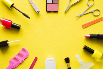 Various decorative makeup cosmetics on yellow background. Different beauty essentials for women. Mockup for special offers as advertising. Empty place for text or logo. Flat Lay. Top view.