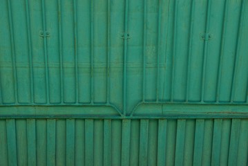 Green old iron texture from a fragment of a fence