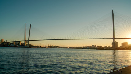 Panoramic view of cable stayed bridge on the sunset. Golden bridge, Russia, Vladivostok city