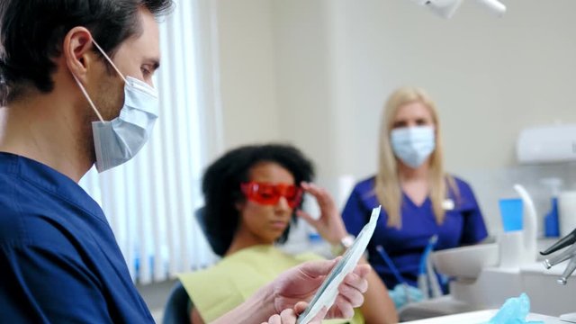 Dentist and his assitant working in private practice.