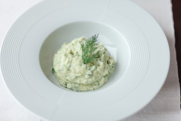 Mashed potatoes with dill in white plate