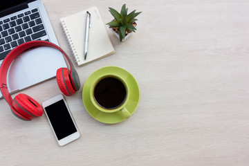 White office workspace with eye glasses,laptop,smart phone and cup of coffee.Top view with copy space.
