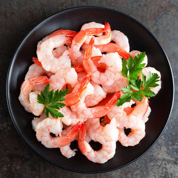 Prawns on plate. Shrimps, prawns. Seafood. Top view. Dark background