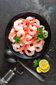 Prawns on plate. Shrimps, prawns. Seafood. Top view. Dark background