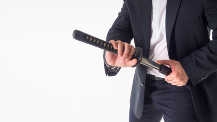 Close-up Of Businessman Removing Sword Over White Background. © Stavros
