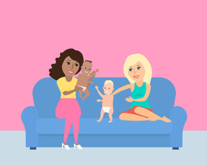 african american and european women play with babys on the sofa