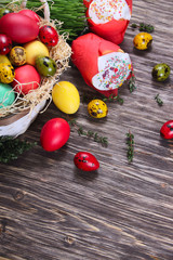 Easter background with a bun with a candle and eggs on a wooden background