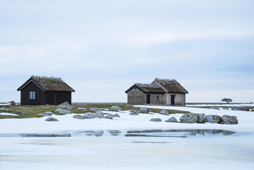 Old cabins in a barren winter landscape