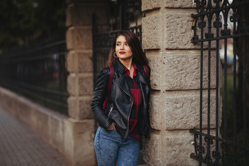 Portrait of a happy woman in a leather jacket outdoor