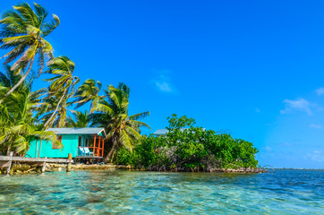 Belize Cayes - Relaxing at Cabin or bungalow on small tropical island at Barrier Reef with paradise beach, Caribbean Sea, Belize, Central America