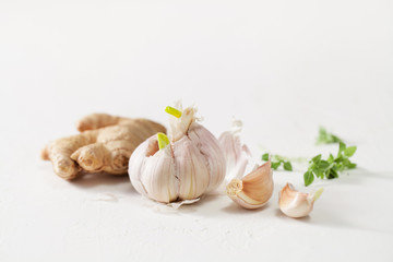 Garlic heads and ginger root on white background