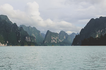 Cliffs and mountains with clouds on a lake