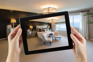 Female Hands Holding Computer Tablet In Room with Photo on Screen. © Andy Dean