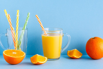 Orange juice on a blue pastel background