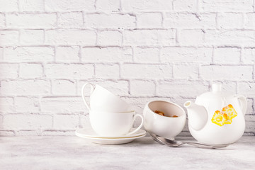 Two cups and teapot for morning tea.
