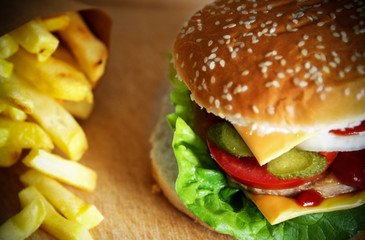 Close up of a hamburger sandwich and french fries