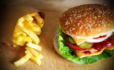 Close up of a hamburger sandwich and french fries