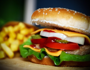 Hamburger and french fries on a wooden table