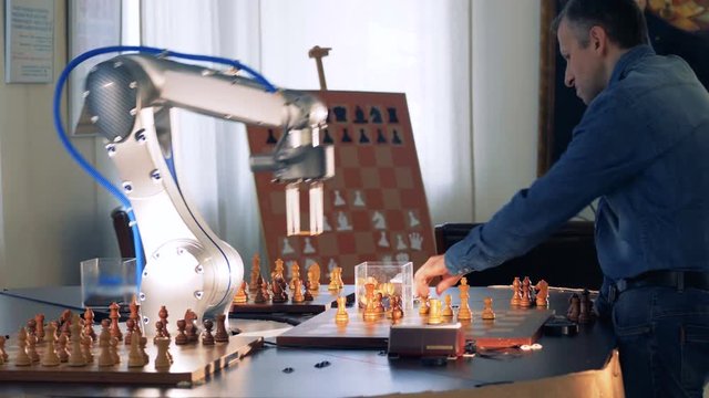 Game between a chess player and a robot.