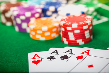 Cards on green felt casino table. Poker chips on table in casino