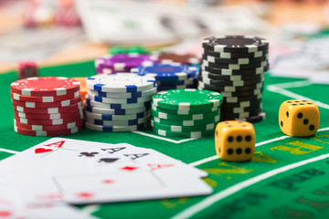 Poker chips on table in casino. Cards on green felt casino table