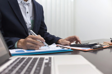 Fototapeta premium Businessman using calculator financial business calculation