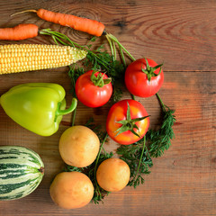 Vegetables laid out on a wooden table. Flat lay,top view. Free space for text.