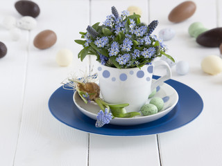 Spring flowers with chocolate easter eggs