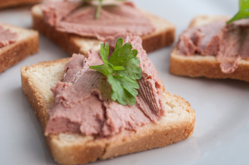 closeup of little toasts with pork and parsley