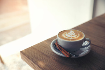 cappuccino or Latte art coffee made from milk on the wood table in coffee shop.