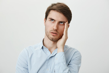 Gosh, so annoying, hope she would not talk to me. Portrait of bothered handsome young man in casual...
