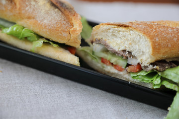 Beef sandwich on wood background