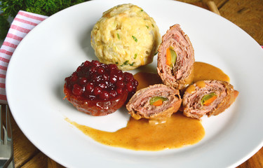 Beef roulade with bread dumpling (German name is Rinderroulade mit Semmelknödel)
Serve with apples roast with honey, cinnamon and  lingonberry jam