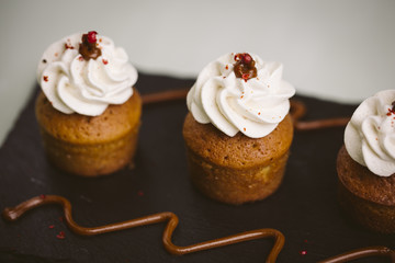 Three small cakes on a green background.