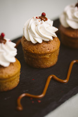 Three small cakes on a green background.